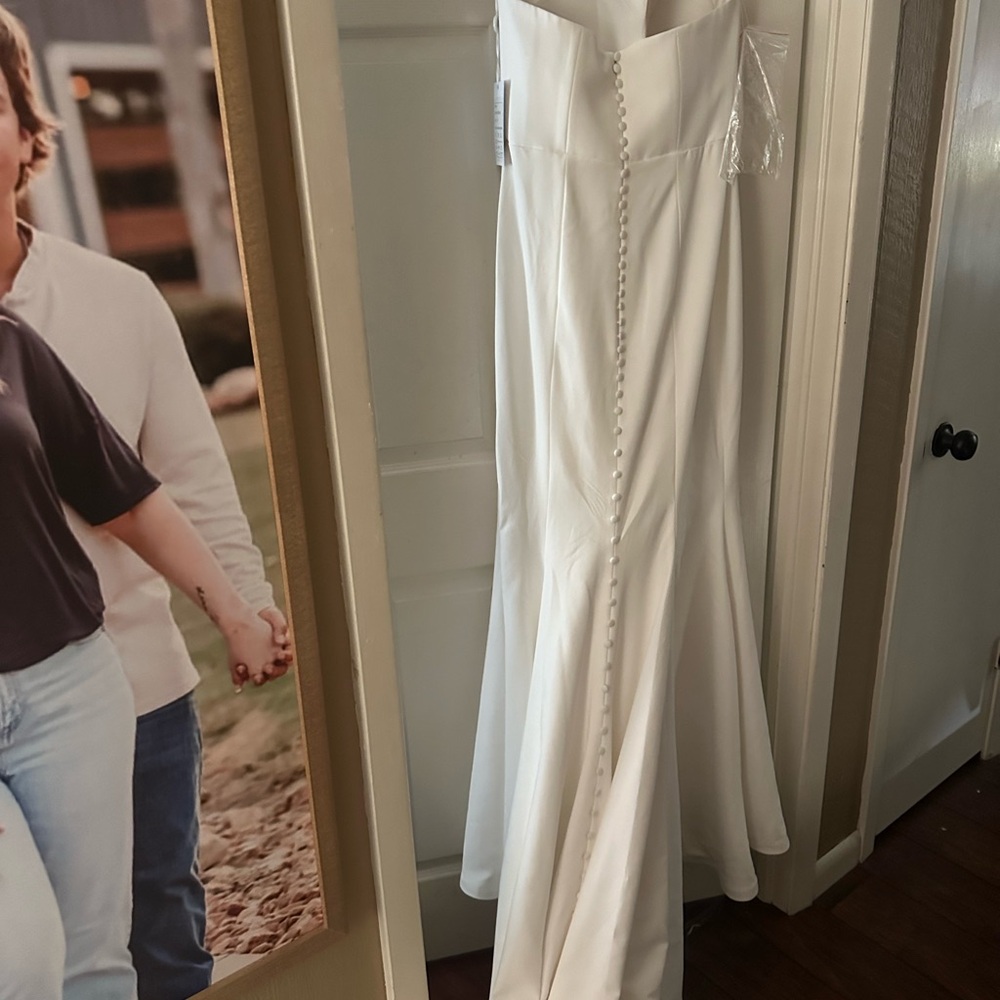 Size 14 wedding dress. New with tags never worn.
